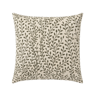 Decorative pillow with leaf pattern on a beige background